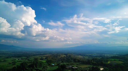 Obraz premium The allure of a landscape filled with the beauty of blue sky, fluffy white clouds, majestic high mountains, and vibrant green plants. Generative AI