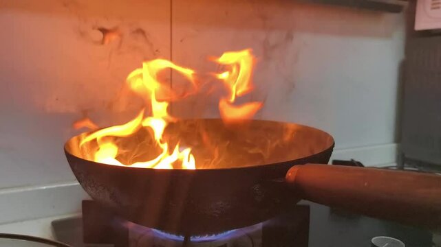 fire over cooking pan in kitchen