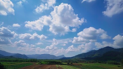 Obraz premium The allure of a landscape filled with the beauty of blue sky, fluffy white clouds, majestic high mountains, and vibrant green plants. Generative AI