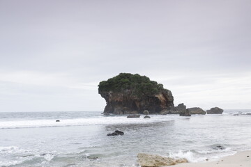 Fototapeta premium View of the ocean and large rocks with crashing ocean waves