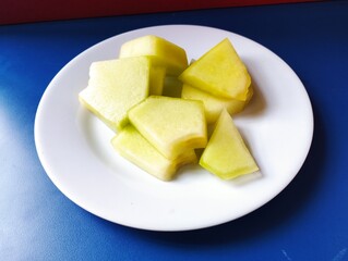 sliced melon on white plate