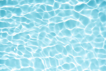 Blue water with ripples on the surface. Defocus blurred transparent blue colored clear calm water surface texture with splashes and bubbles. Water waves with shining pattern texture background.