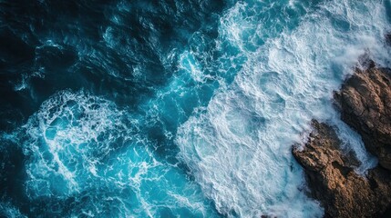 Close up aerial view of ocean waves crashing against rocky shorelines