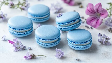 Obraz premium Blue macarons on a light background adorned with flowers Close up shot