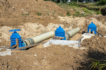 New fiber glass water pipeline in trench. Replacement of old rusty tubes by new one