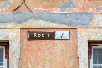 old enamel streetname kooli 2 in Tallinn, Estonia at an old wall in the old town