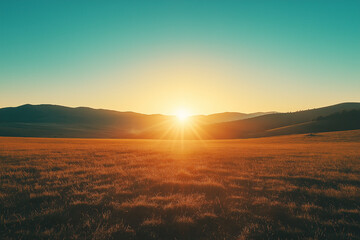 Sunrise over a wide open field, with warm golden light spreading across the landscape. The fresh start of a new day signifies hope and tranquility in nature.