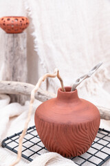 Stilllife with different driftwood branches and cotton mesh sack beige fabric on background. Vertical
