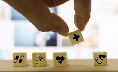 Hand arranging wood block cube shape with icon healthcare medical, Insurance for your health concept