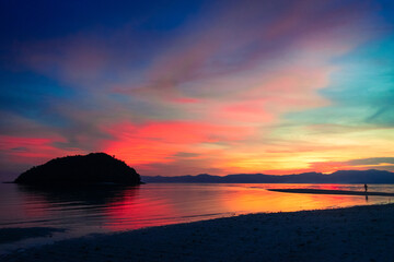 Colorful rainbow sunset at sea. Bonbon Beach, Romblon Island, Philippines