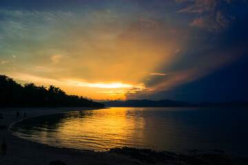 Majestic golden sunset at sea. Bonbon Beach, Romblon Island, Philippines