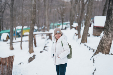 Obraz premium Woman tourist with Cute fox on snow in winter season at Zao fox village, traveler sightseeing Miyagi prefecture. landmark and popular for attraction near Sendai, Tohoku, Japan. Travel and Vacation