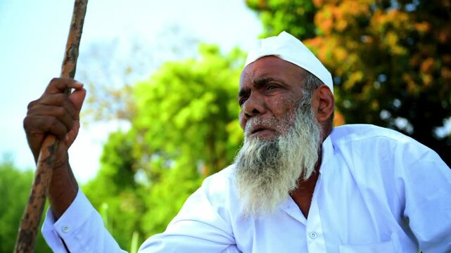 Elderly Man Talking While Sitting Outdoors