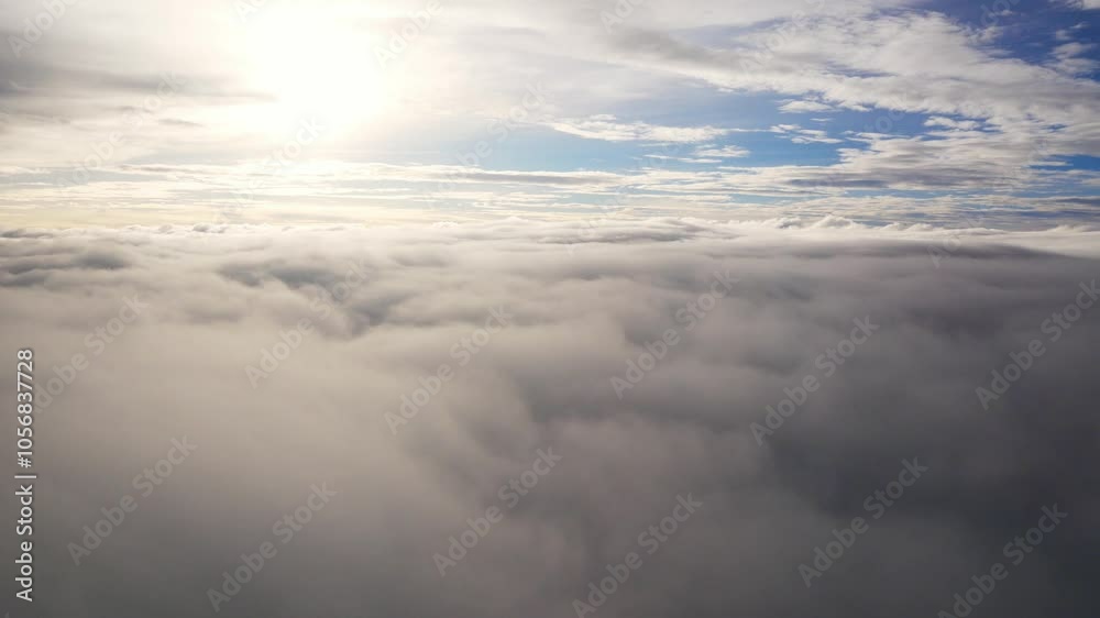 Wall mural aerial view over cloudscape from airplane flying in sunset sky time with thick fog above the beautif