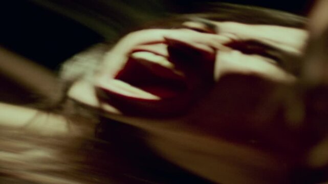 Contorted reflection in distorting mirror of emotional man screaming in dark room, conveying raw emotion - pain or rage