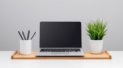 Fototapeta premium Minimalist Workspace with Laptop Plant and Pencils