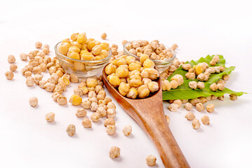 A bowl of chickpeas is on a white table