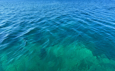 Ocean blue waves clear water surface.