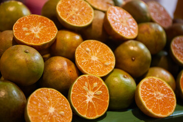 Orange fruit in a market, Slices of tangerines background