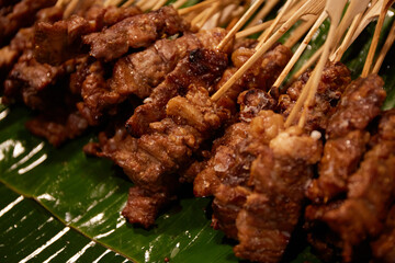 Grilled pork satay on banana leaf, Thai street food