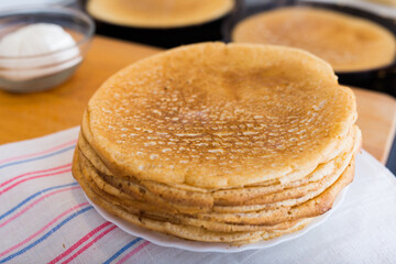 cooking traditional pancakes from wheat flour in the kitchen