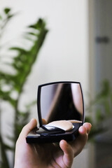 Reflection in a pocket mirror. The girl admires herself.