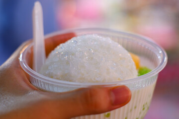 Sweet dessert with coconut milk and ice, sold in a Thai market.