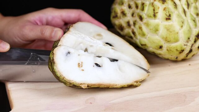 Cutting a Custard Apple Open