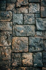 Fototapeta premium A close-up shot of a stone wall with a fire hydrant in the center