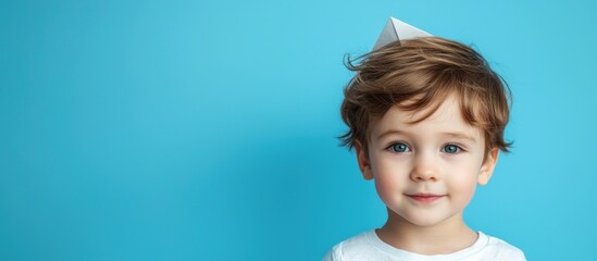 Cute Little Boy With The Paper Plane On The Blue Background