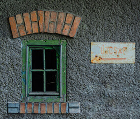 Old rustic window with weathered street sign.