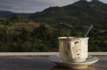 empty coffee cup on mountain nature landscape background. Good luck in drinking coffee