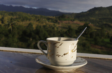 empty coffee cup on mountain nature landscape background. Good luck in drinking coffee