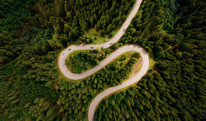 Curve asphalt road on mountain forest summer. Aerial view of the road passing through the mountain and green forest.