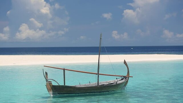 white sandy beach and traditional boat dhoni maldives