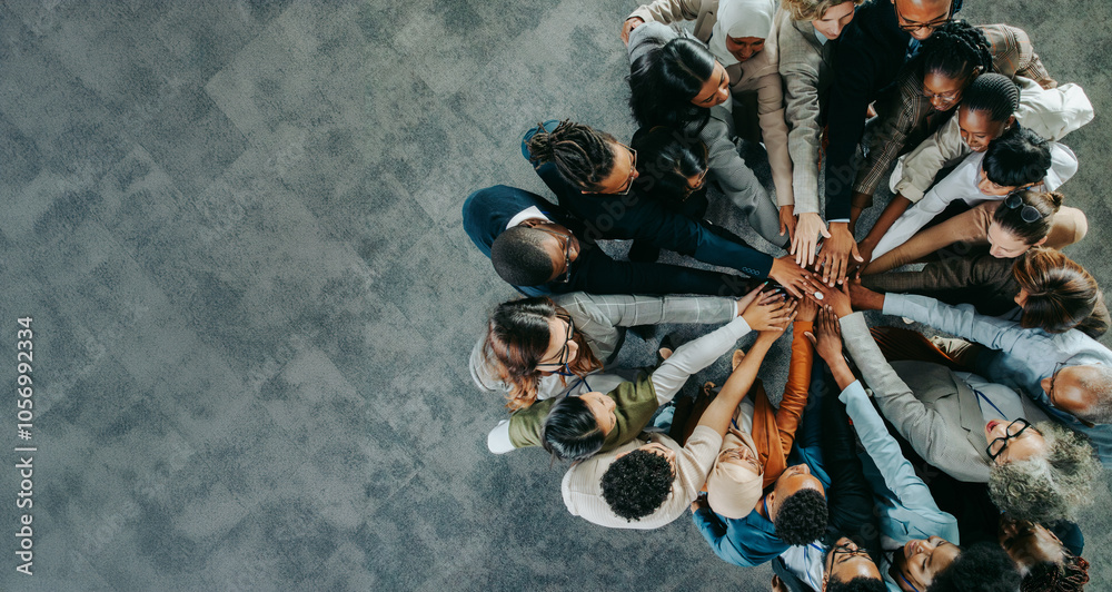 Wall mural diverse business team uniting with hands together in a show of teamwork and collaboration