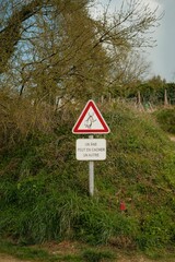 Caution sign with  Animal sign installed in an open field