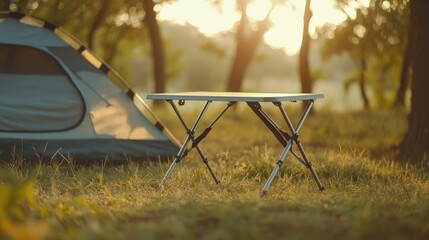 Compact camping table with minimalist style, set up by a tent on grass, lightweight and easy to transport.