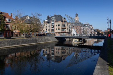 View of the old Dender River and 'Vlasmarktbrug', (Flax market bridge), in the city center of Dendermonde, on a sunny autumn day. Copy space below.