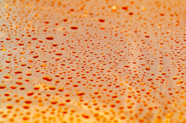 Clear water droplets on orange and red gradient color cover background. Water droplets concept