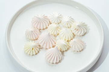 cakes with berries, chocolate and nuts on a white background