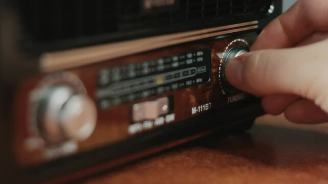 Old-fashioned radio close-up. Male hand searching channel