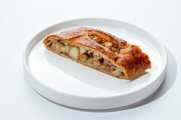 cakes with berries, chocolate and nuts on a white background