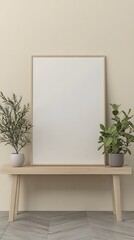 A vertical blank poster frame is placed on top of the console table, with plants in wooden pots beside it.