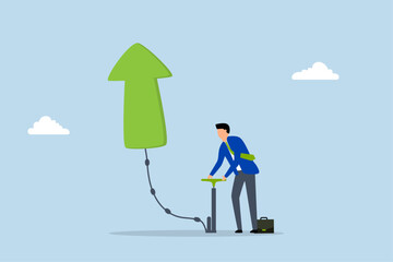 Growing business, Businessman is inflating an air pump to make a green arrow float upwards. 
