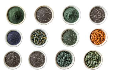 Variety of colorful superfood powders and seeds in bowls, isolated on white background.