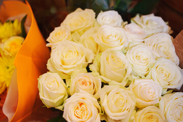 A large and beautiful bouquet of white roses. A gift for a woman for a holiday.