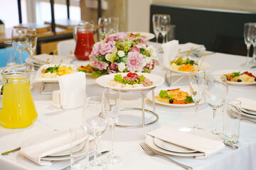 A served festive table with a variety of snacks and drinks. catering for a holiday.