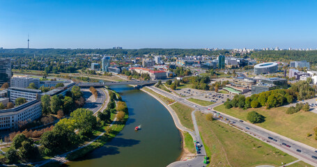 Fototapeta premium Aerial view of Vilnius, Lithuania, featuring the Neris River, Vilnius TV Tower, and National Gallery of Art amidst historical and modern architecture.