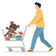 Smiling man pushing a shopping cart filled with wrapped gifts and a teddy bear.